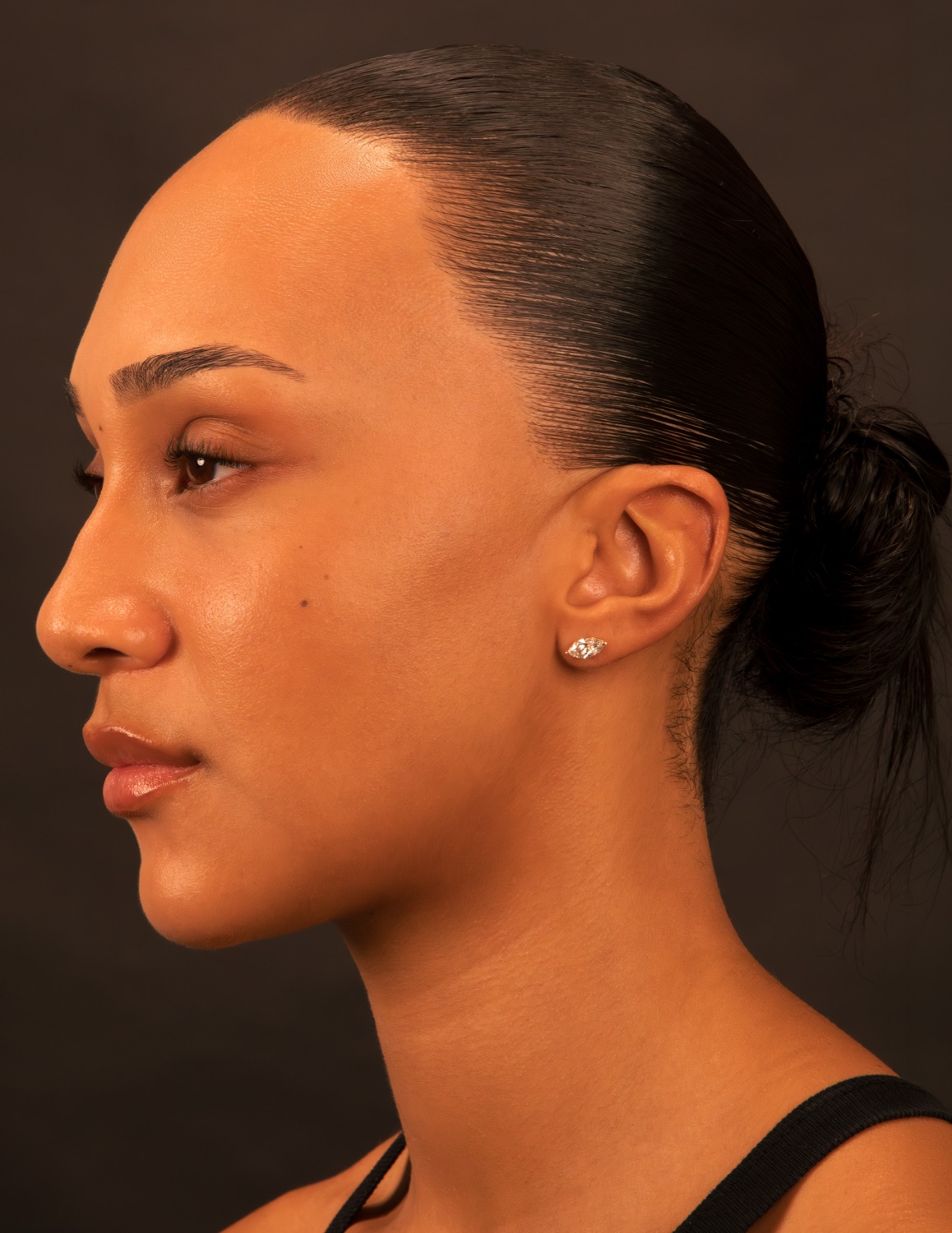 Model wearing a marquise diamond stud earring