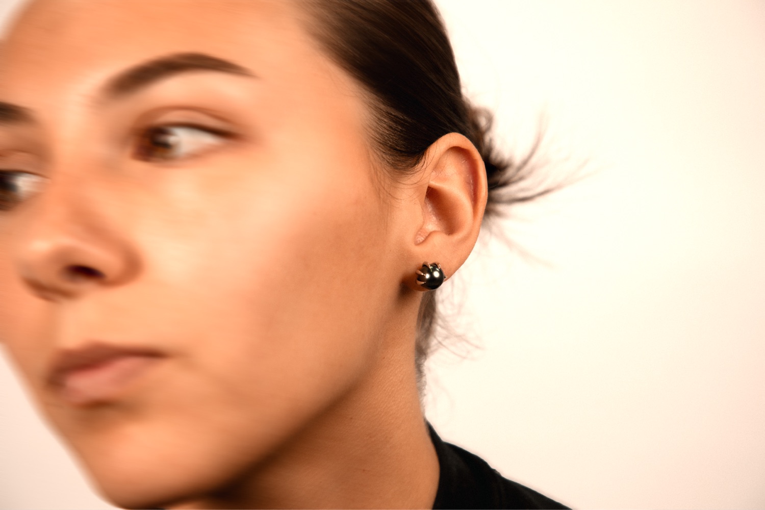 A model wearing the Panther earring, a Tahitian pearl in a claw setting