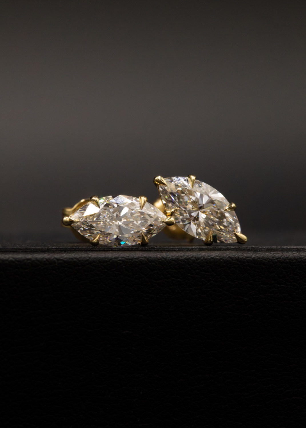 Marquise diamond studs in yellow-gold talon-claw settings