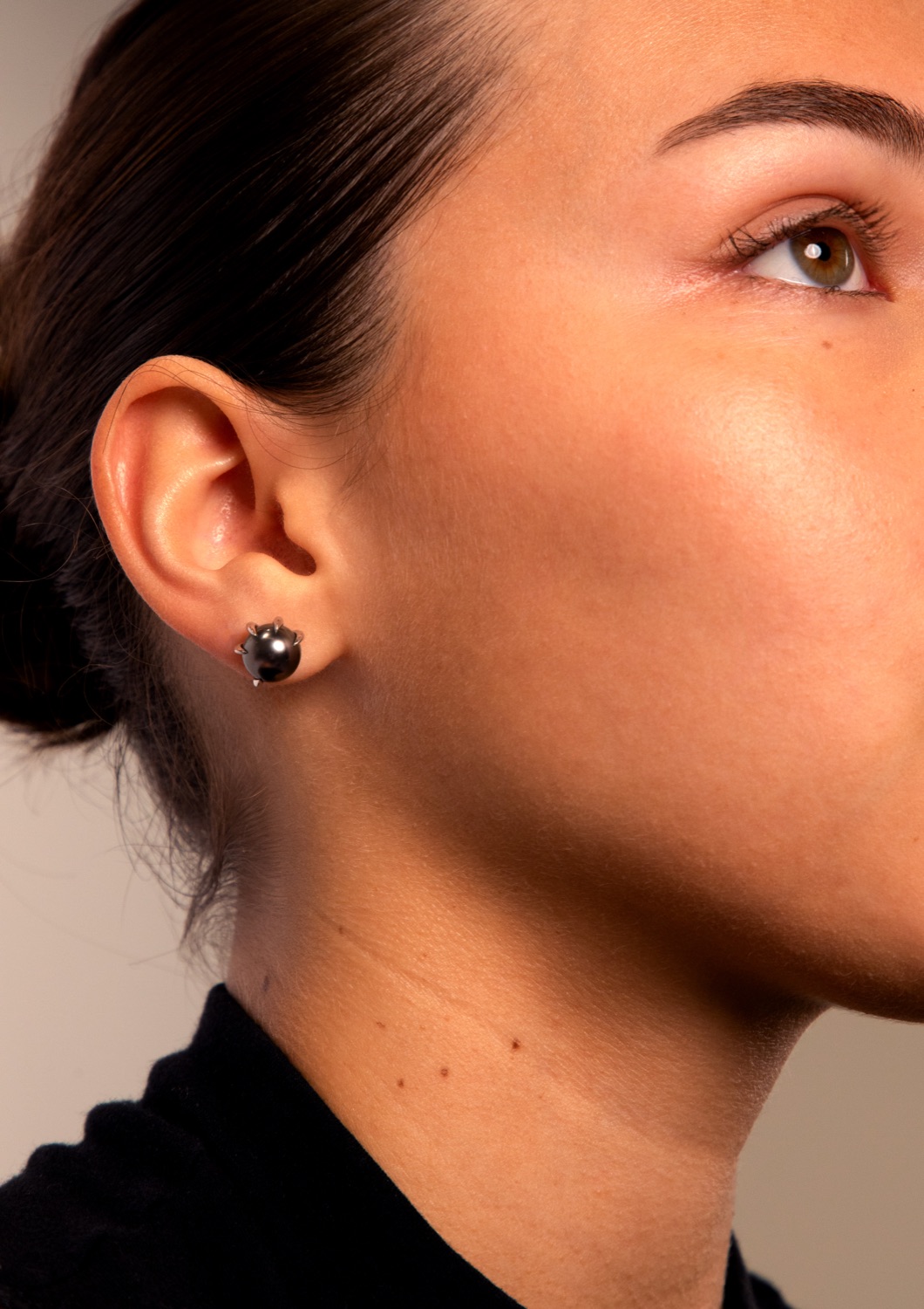 Model wearing a Panther earring, a Tahitian pearl in a claw setting