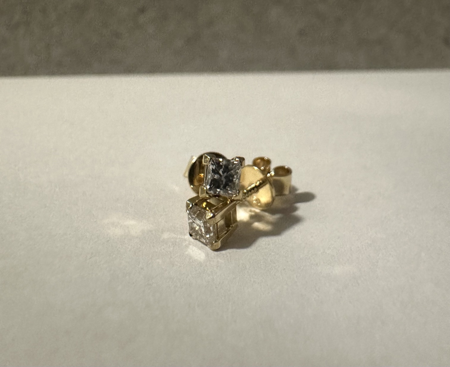 Princess-cut diamond studs in yellow gold